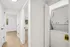 Bright hallway with hardwood floors and in-unit laundry setup, offering modern convenience and style.