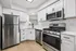 Elegant modern kitchen with stainless steel appliances, sleek white cabinetry, and a chic subway tile backsplash.