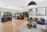 Elegant open-concept lounge area with modern furnishings, stylish decor, and natural light from large windows.