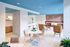 Stylishly designed lounge area featuring a vibrant blue ceiling, modern furniture, and a cozy seating arrangement with warm lighting.
