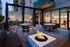 Modern rooftop terrace with stylish outdoor seating, ambient lighting, and a cozy fire pit, perfect for evening gatherings.