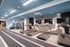 Modern fitness center featuring state-of-the-art treadmills, ellipticals, and stylish wall art for an inspiring workout experience.