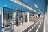 Modern fitness center with state-of-the-art gym equipment, sleek blue ceiling, and stylish wall art.