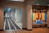 Modern fitness area with treadmills, vibrant workout bands, and sleek wooden flooring, ideal for active lifestyles.