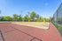 Inviting sand volleyball court set against a backdrop of lush green trees, perfect for outdoor recreation.