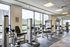 Bright and modern fitness center with state-of-the-art Cybex equipment, overlooking scenic views through large windows.