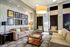 Elegant living room with modern decor, featuring cozy sofas, stylish art pieces, and large windows for natural light.