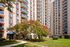 Charming apartment building with modern balconies and beautifully landscaped gardens, offering a serene and pleasant environment.