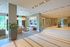 Elegant apartment lobby featuring modern seating, plush decor, and large windows offering scenic views.