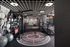 Modern fitness center with cutting-edge equipment, including treadmills, weight racks, and exercise balls, set in a sleek industrial design.