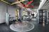 Modern gym with state-of-the-art equipment, vibrant wall art, and ample natural light, perfect for energizing workouts.