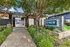Inviting entrance to leasing center with lush greenery and modern design at reNEW Aster Apartments.