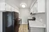 Modern kitchen with sleek countertops, spacious cabinetry, and stainless steel appliances in an elegant apartment setting.