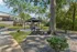 Inviting outdoor pavilion with picnic tables nestled among lush greenery, perfect for relaxation and gatherings.