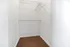 Spacious walk-in closet with ample shelving and plush carpet, perfect for organizing your wardrobe.