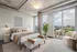 Modern bedroom with city skyline view featuring a stylish bed, contemporary decor, and large windows for abundant natural light.