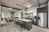 Modern open-plan kitchen and dining area featuring sleek cabinetry, stainless steel appliances, and a stylish breakfast bar with seating.