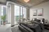 Modern apartment bedroom with stunning cityscape views, featuring floor-to-ceiling windows and chic industrial design.