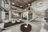 Contemporary loft apartment showcasing a spacious open-concept living area with stylish modern furnishings, industrial accents, and a sleek kitchen with a dining table for six.