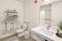 Chic bathroom with modern fixtures, spacious vanity, and tasteful decor.