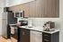 Contemporary kitchen with stainless steel appliances and wood cabinetry.
