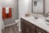 Sleek bathroom featuring modern fixtures, a large mirror, and chic decor accents.