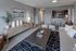 Stylish living room with modern decor, cozy seating, and open kitchen view.
