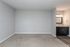 Bright and spacious room featuring a modern vanity area with a large mirror.