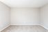 Spacious, light-flooded bedroom with soft carpet and neutral wall tones.