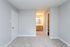 Spacious bedroom with soft carpeting and access to ensuite bathroom.