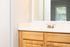 Elegant bathroom vanity with a wooden cabinet and polished faucet.