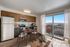 Bright and inviting open-concept kitchen and dining area with modern appliances and balcony view.