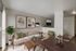 Elegant living room with modern art decor, plush seating, and abundant natural light.