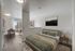 Modern bedroom with wooden floor, cozy bed, and stylish decor leading to a bright dining area with scenic balcony views.