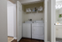Convenient in-unit laundry with washer and dryer, complemented by shelving for ample storage.