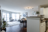 Spacious and modern open-concept apartment living area with elegant decor, natural light, and a cozy dining setup.