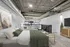 Chic industrial loft bedroom with modern decor, cozy linens, and stylish exposed ductwork.