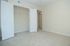 Bright and inviting bedroom with plush carpet and spacious closet, perfect for comfortable living.