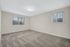 Spacious and airy bedroom with plush carpet, large windows for natural light, and neutral walls offering a blank canvas for personalization.