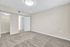 Bright and spacious bedroom with fresh carpets, neutral walls, and a walk-in closet with ample storage space.