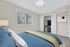 Bright bedroom with a cozy bed, built-in closet, and large window offering scenic views.