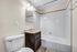 Modern bathroom with elegant lighting, sleek white tiles, and a stylish vanity offering a clean and contemporary design.