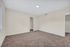 Spacious bedroom with plush carpeting, soft neutral walls, and ample closet space perfect for cozy living.