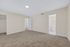 Spacious bedroom with plush carpet, walk-in closet, and en-suite bathroom, promising comfort and privacy.