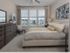 Dwell Nona Place, interior, spacious guest bedroom, large windows, large bed, carpet, dresser