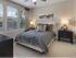 Dwell Nona Place, interior, spacious master bedroom, large windows, carpet, ceiling fan
