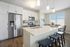 Apartment kitchen at Seasons at Mount Pleasant Apartments in Mount Pleasant, Wisconsin featuring contemporary layouts, cabinetry, and appliances.