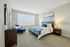 Bedroom at Seasons at Mount Pleasant Apartments in Mount Pleasant, Wisconsin offering functional space for rest and comfort.