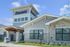 Clubhouse exterior at Seasons at Franklin Apartments in Franklin, Wisconsin showcasing community gathering spaces and on-site amenities.