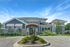 Clubhouse exterior at Seasons at Orchard Hills in Oak Creek, Wisconsin, featuring the main community building and surrounding landscaped areas.